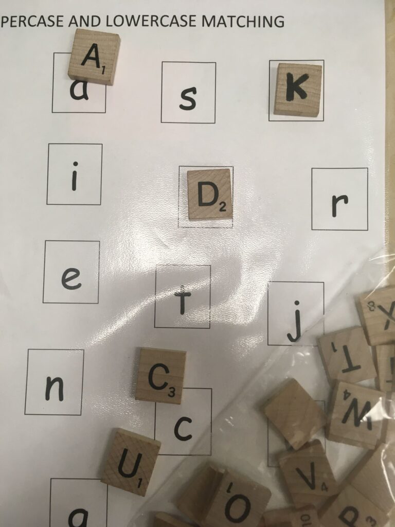 Matching Scrabble tiles to lowercase letters on a page